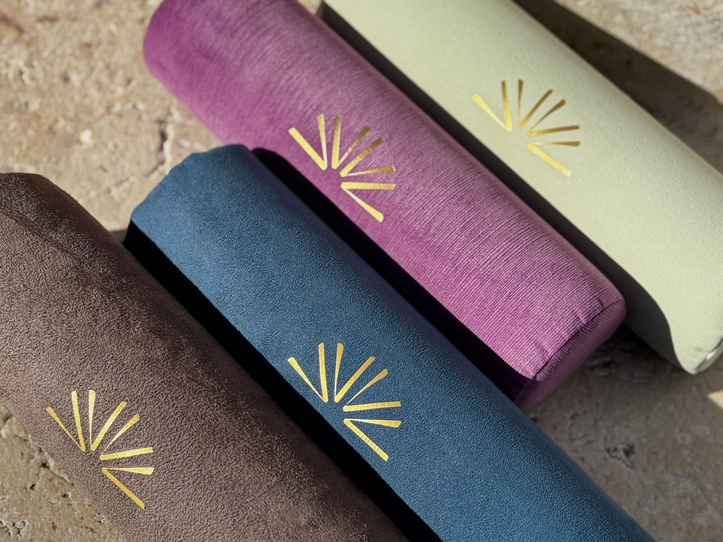 Four Axis Rolls with gold geometric logo on textured surface